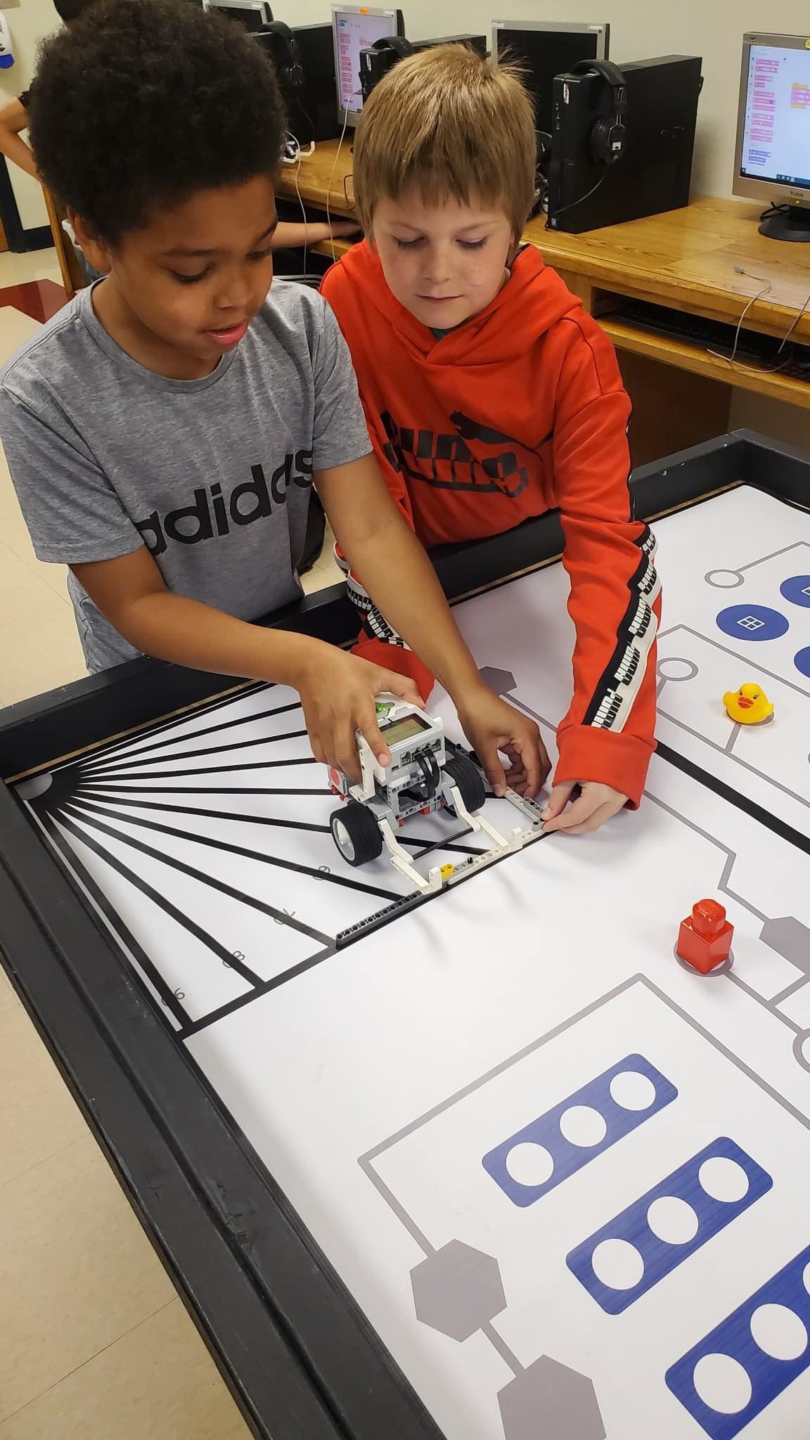  boys working on robotics